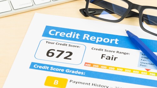 Fair credit score report with pen and keyboard; document is mock