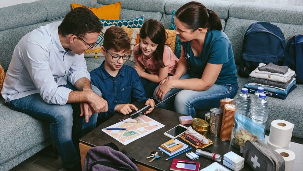 Family going over Emergency Preparedness Plan in Living Room