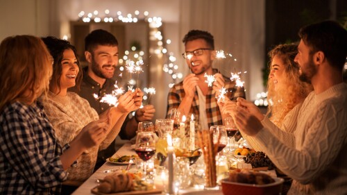 happy friends having christmas dinner at home