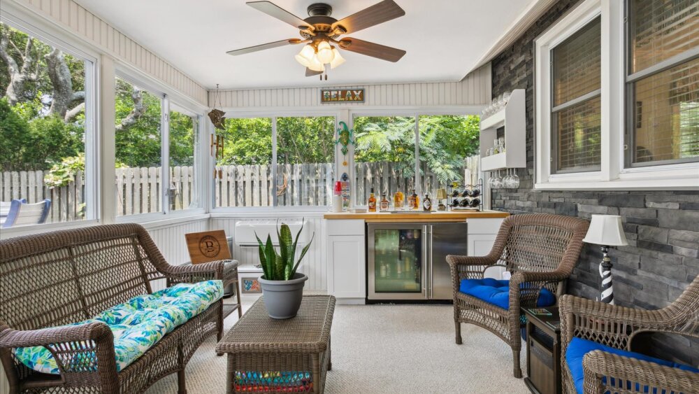 E Ocean View Norfolk, Virginia Sun Room with a beautifully staged seating area and bar.