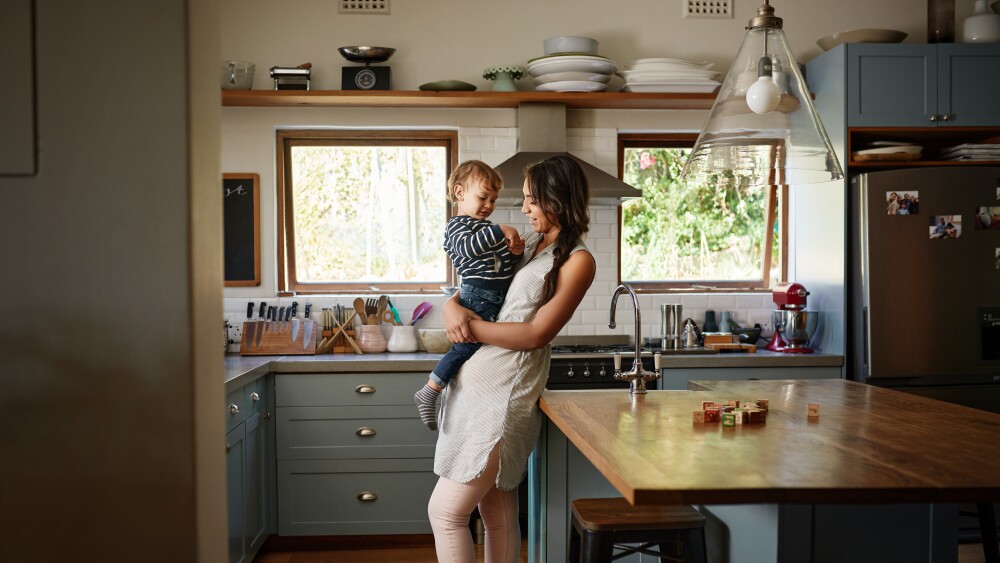 mom and child standing in kitchen of home